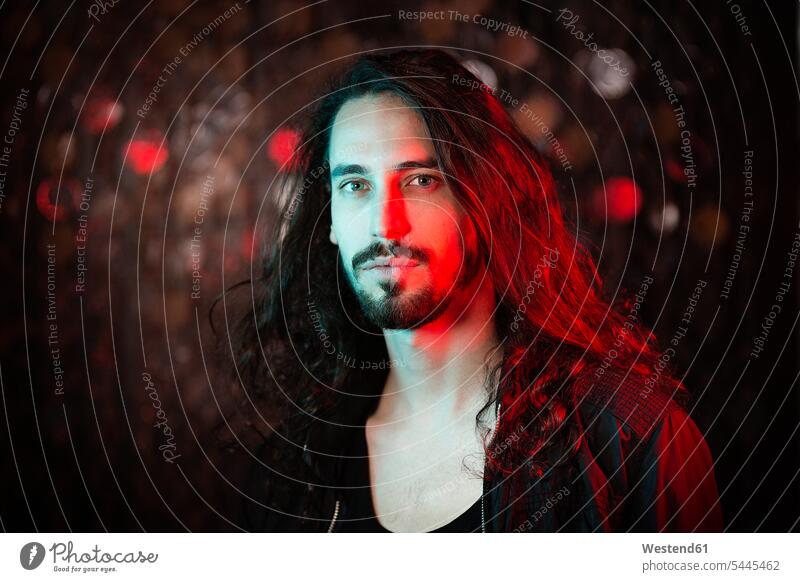 Portrait of bearded long-haired young man in red light portrait portraits men males Adults grown-ups grownups adult people persons human being humans