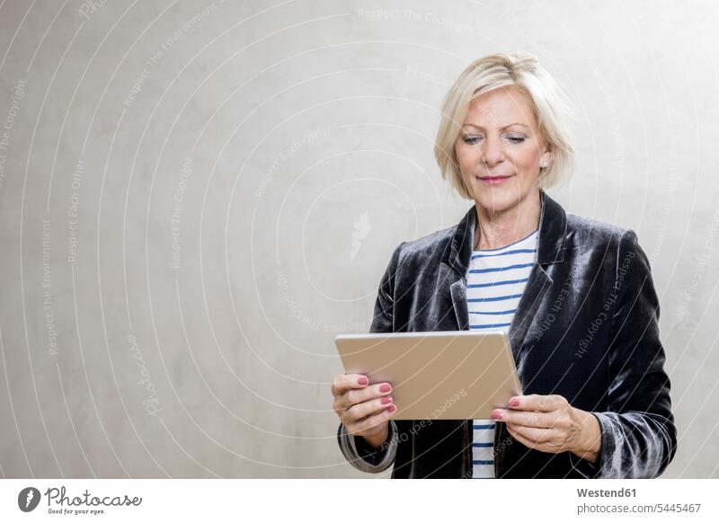 Portrait of senior woman using tablet digitizer Tablet Computer Tablet PC Tablet Computers iPad Digital Tablet digital tablets portrait portraits females women