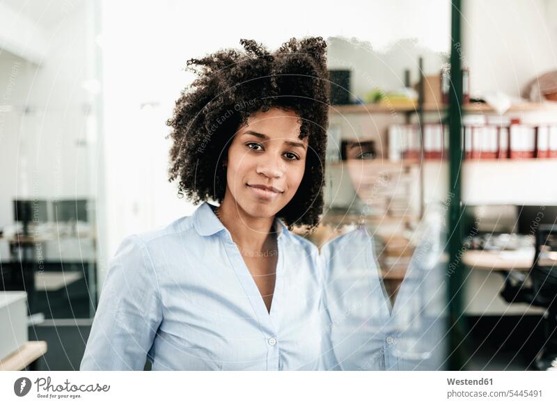Portrait of confident young woman in office females women smiling smile portrait portraits Adults grown-ups grownups adult people persons human being humans