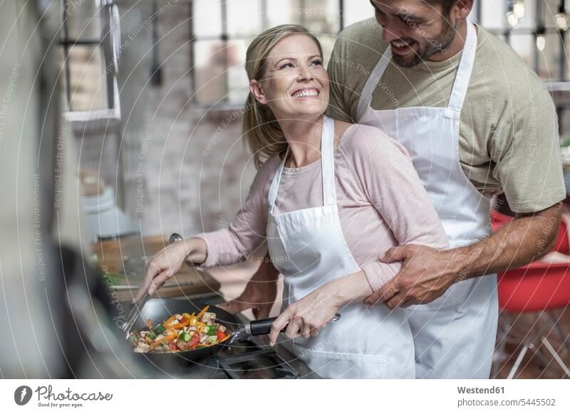 Loving couple preparing healthy food cooking twosomes partnership couples Fun having fun funny people persons human being humans human beings Frying pan