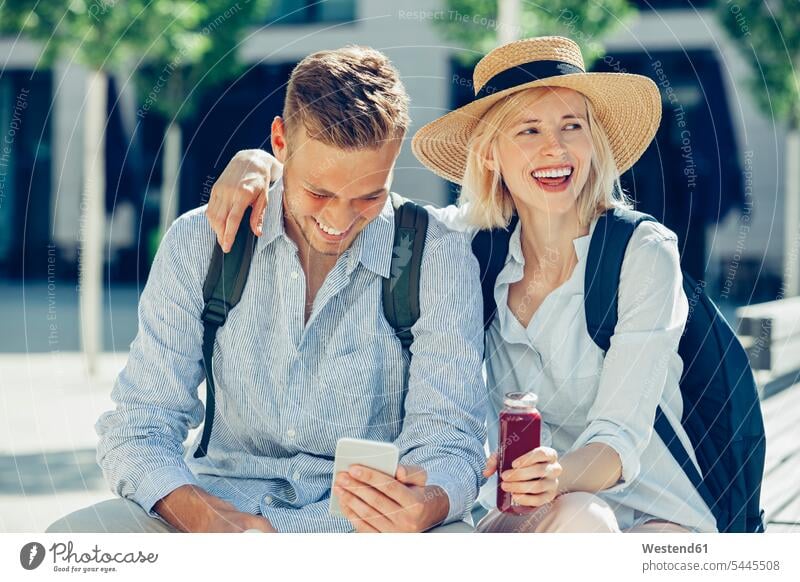 Two tourists having fun in the city couple twosomes partnership couples people persons human being humans human beings Smartphone iPhone Smartphones laughing