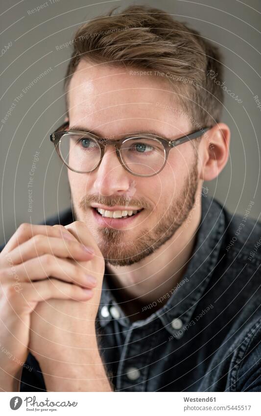 Portrait of smiling young man with glasses specs Eye Glasses spectacles Eyeglasses portrait portraits men males smile Adults grown-ups grownups adult people