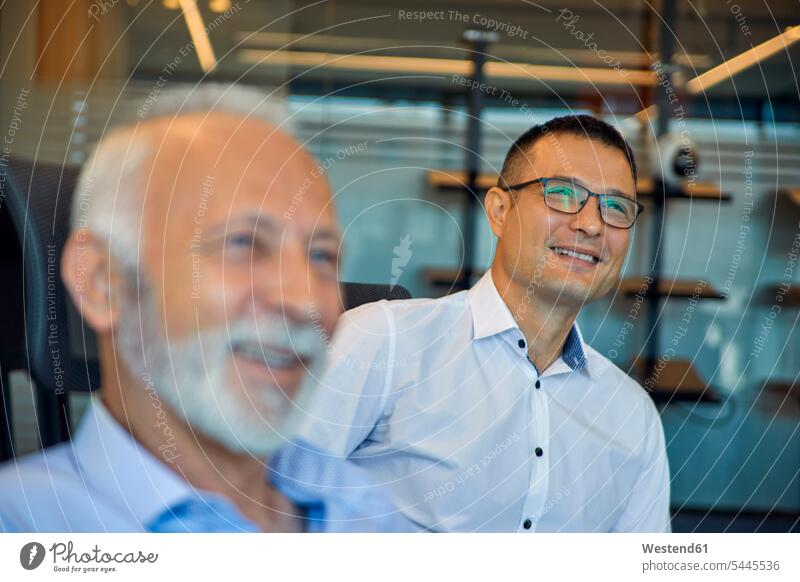 Two smiling businessmen in office colleagues smile offices office room office rooms Businessman Business man Businessmen Business men Business Meeting