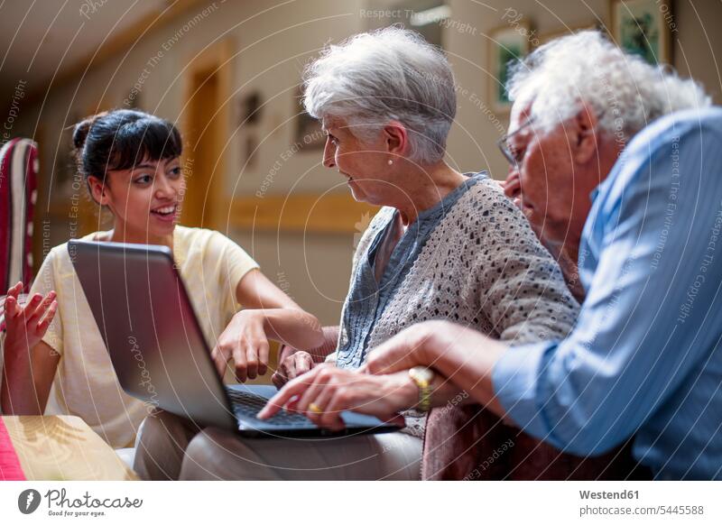 Nurse teaching seniors in retirement home, how to use laptop Laptop Computers laptops notebook Curiosity Curious using laptop using a laptop Using Laptops