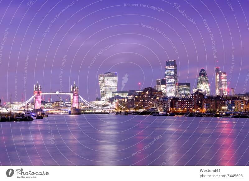 UK, London, skyline with River Thames and Tower Bridge at blue hour illuminated lit lighted Illuminating tower towers skyscraper skyscrapers multistory building
