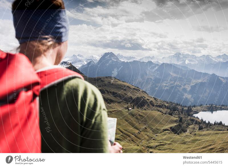 Germany, Bavaria, Oberstdorf, hiker with map in alpine scenery woman females women mountain range mountains mountain ranges hiking Adults grown-ups grownups