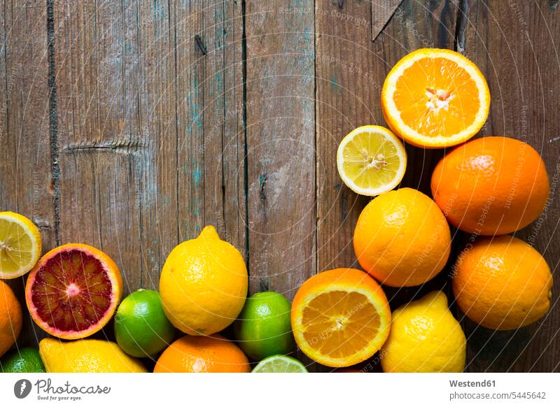 Sliced and whole lemons, oranges and limes on wood rich in vitamines blood orange blood oranges variation various different circle circles circular sort sorts