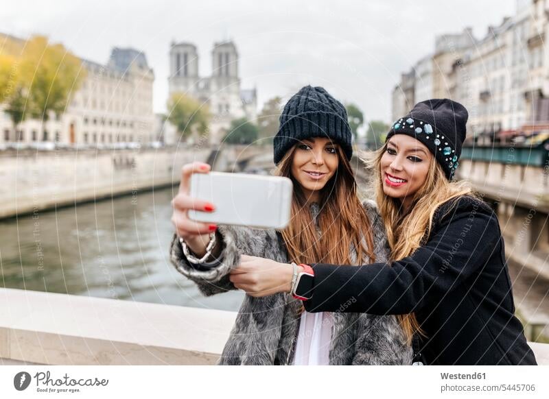 France, Paris, tourists taking selfie with cell phone female friends Selfie Selfies mate friendship autumn fall female tourist photographing woman females women
