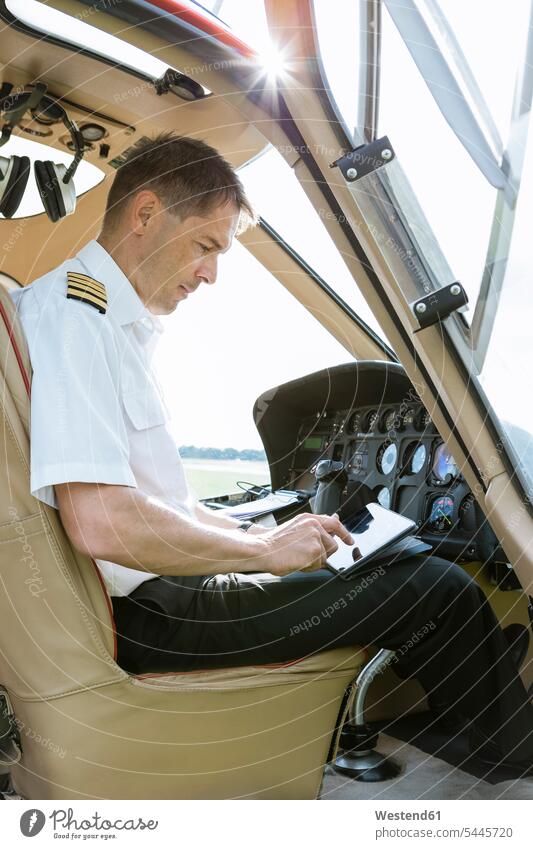 Pilot using tablet in cockpit of a helicopter digitizer Tablet Computer Tablet PC Tablet Computers iPad Digital Tablet digital tablets pilot pilots computer