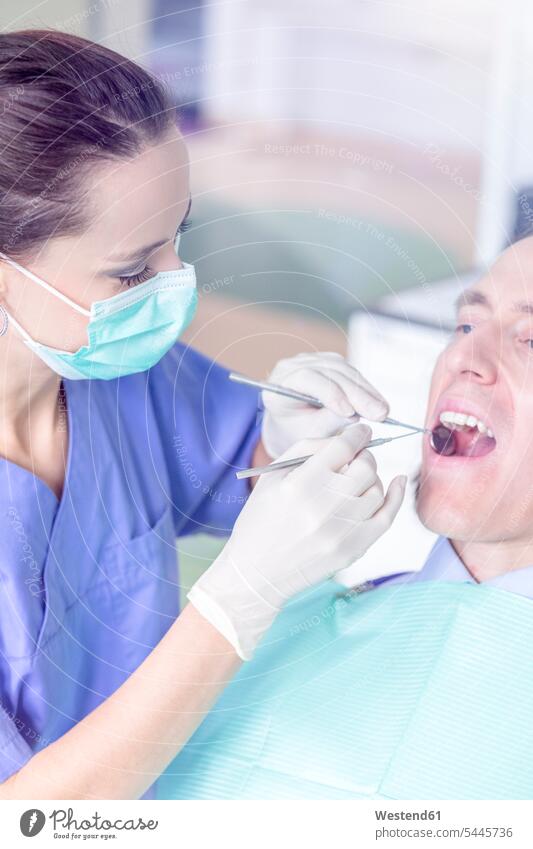 Patient receiving treatment at the dentist Medical Treatment treatments female dentist female dentists female dental surgeons patient patients