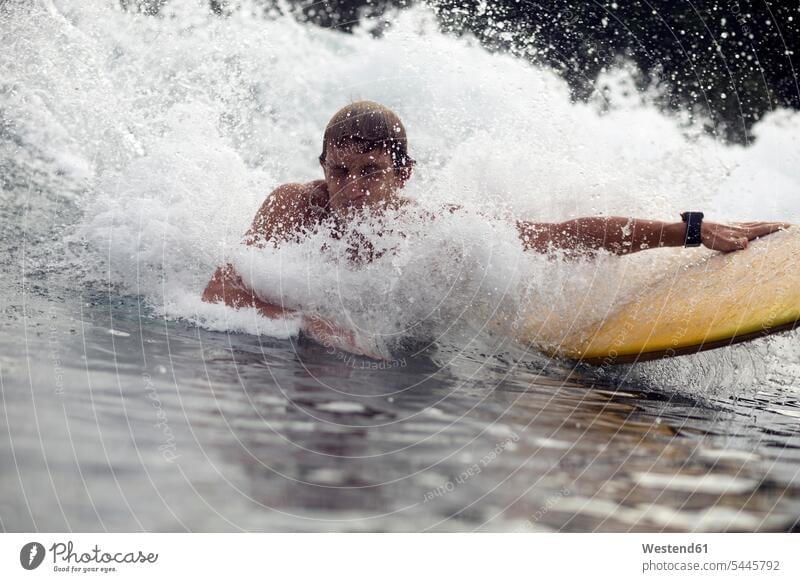 Indonesia, Java, water splashing over man surfing surfboard surfboards Sea ocean surfer surfers surf ride surf riding Surfboarding wave waves water sports