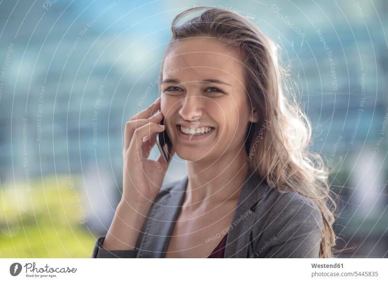 Portrait of a young businesswoman females women on the phone call telephoning On The Telephone calling smiling smile career portrait portraits businesswomen