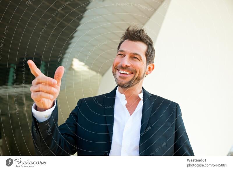 Portrait of confident businessman outdoors pointing his finger smiling smile Businessman Business man Businessmen Business men business world business life