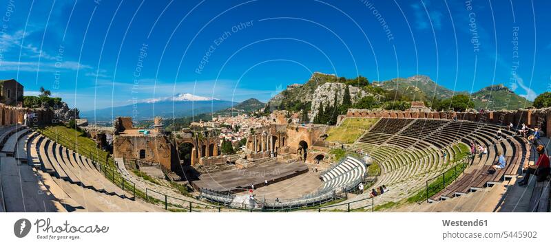 Italy, Sicily, Taormina, Teatro Greco with Mount Etna in the background tourist attraction tourist attractions Stage outdoors outdoor shots location shot