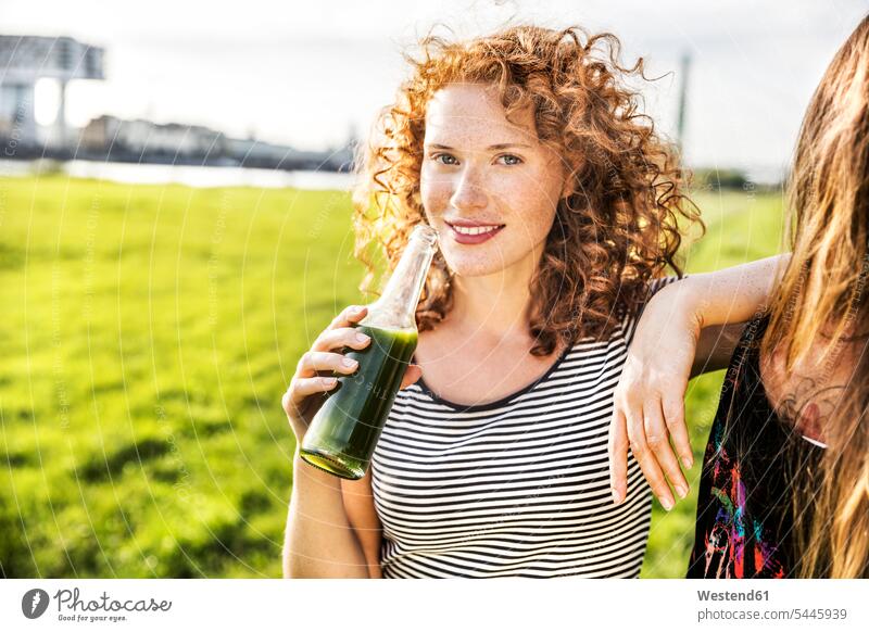 Germany, Cologne, portrait of redheaded young woman enjoying beverage females women portraits Adults grown-ups grownups adult people persons human being humans
