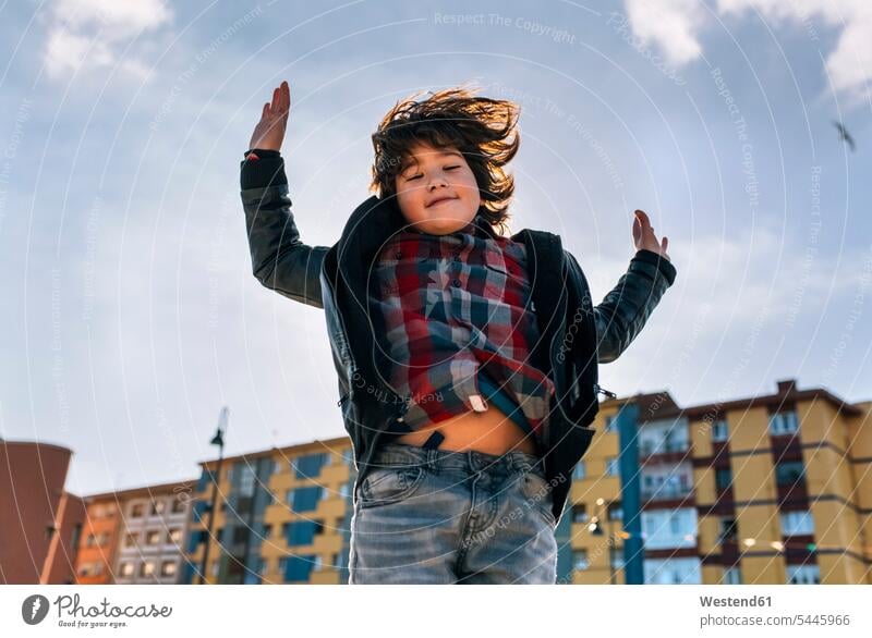 Boy jumping in the air Leaping portrait portraits boy boys males jumps child children kid kids people persons human being humans human beings jump in the air