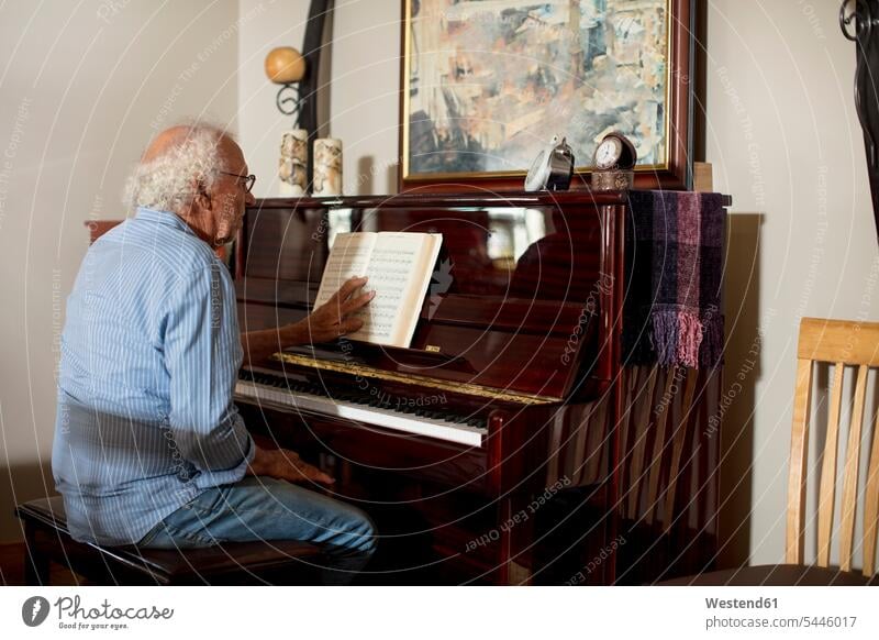 Senior man playing piano at retirement home pianos nursing home Piano playing playing the Piano senior men senior man elder man elder men senior citizen