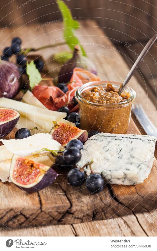 Cheese platter with fruits and fig mustard food and drink Nutrition Alimentation Food and Drinks Ham Fruit Fruits knife knives blue grape red grape blue grapes