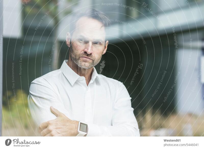 Businessman looking out of window portrait portraits Business man Businessmen Business men serious earnest Seriousness austere business people businesspeople