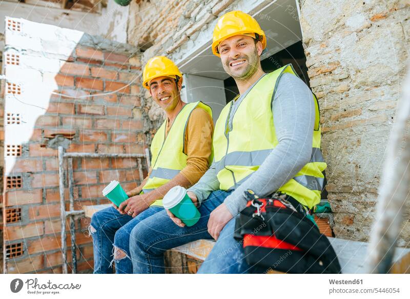 Construction workers having a coffee break on construction site - a ...