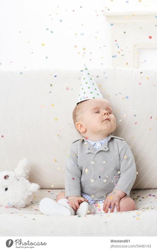 Portrait of baby boy with eyes closed wearing paper hat confetti baby boys male infants nurselings babies people persons human being humans human beings Cap