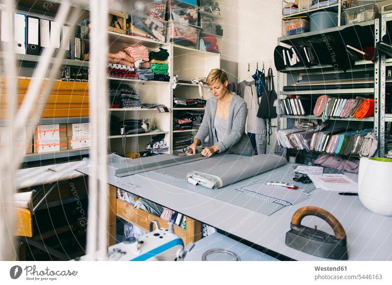 Fashion designer working on template in studio At Work woman females women seamstress seamstresses Adults grown-ups grownups adult people persons human being