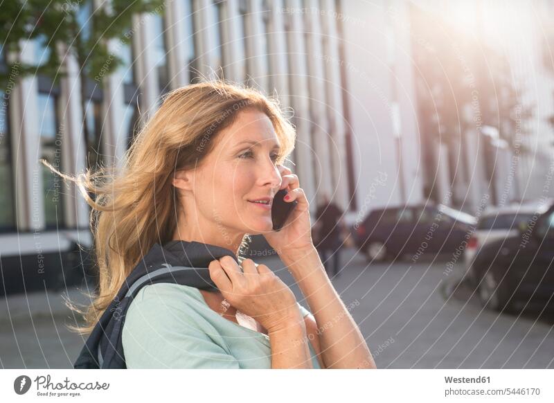 Portrait of woman on cell phone in the city portrait portraits on the phone call telephoning On The Telephone calling businesswoman businesswomen business woman