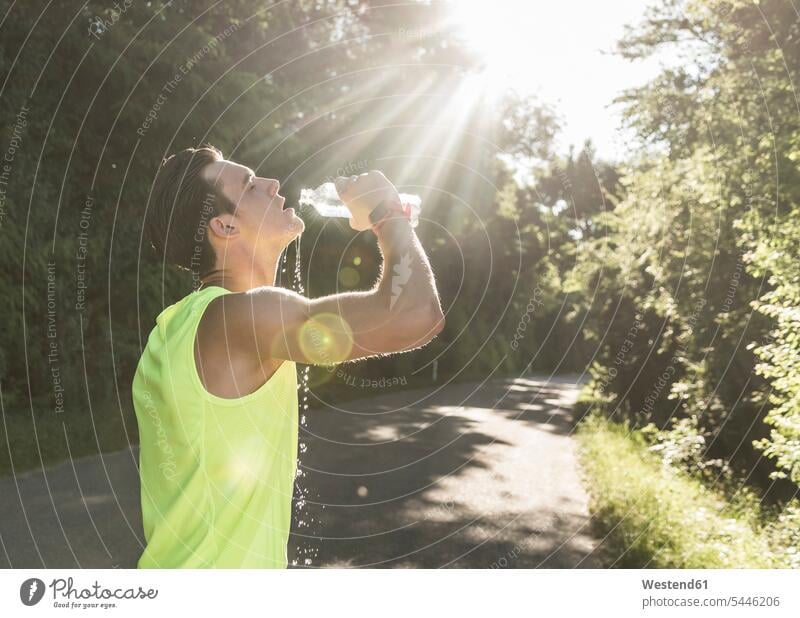 Jogger in the park drinking water parks jogger joggers exercising exercise training practising sportive sporting sporty athletic Water Jogging fitness sports