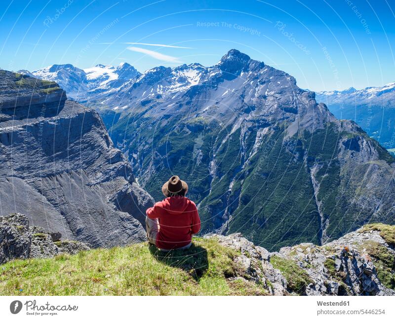 Italy, Lombardy, Sondrio, hiker resting with view to Stelvio Pass and Ortler Cancano nature natural world View Vista Look-Out outlook Travel sky skies leisure