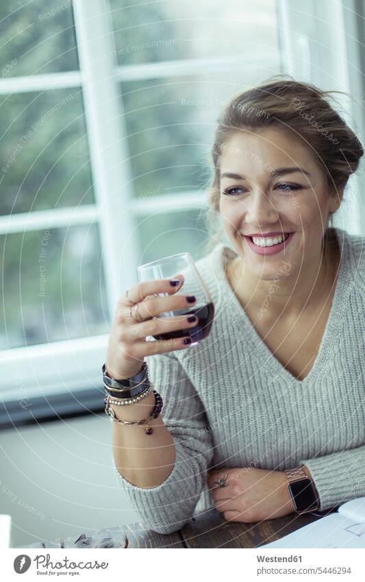 Portrait of smiling young woman with glass of coffee portrait portraits females women Adults grown-ups grownups adult people persons human being humans