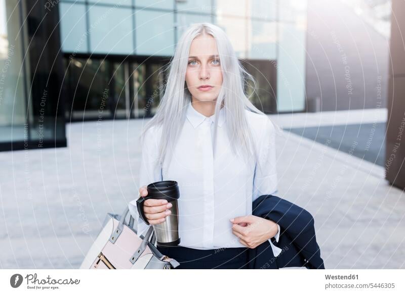 Portrait of serious young businesswoman in the city Coffee businesswomen business woman business women portrait portraits earnest Seriousness austere females