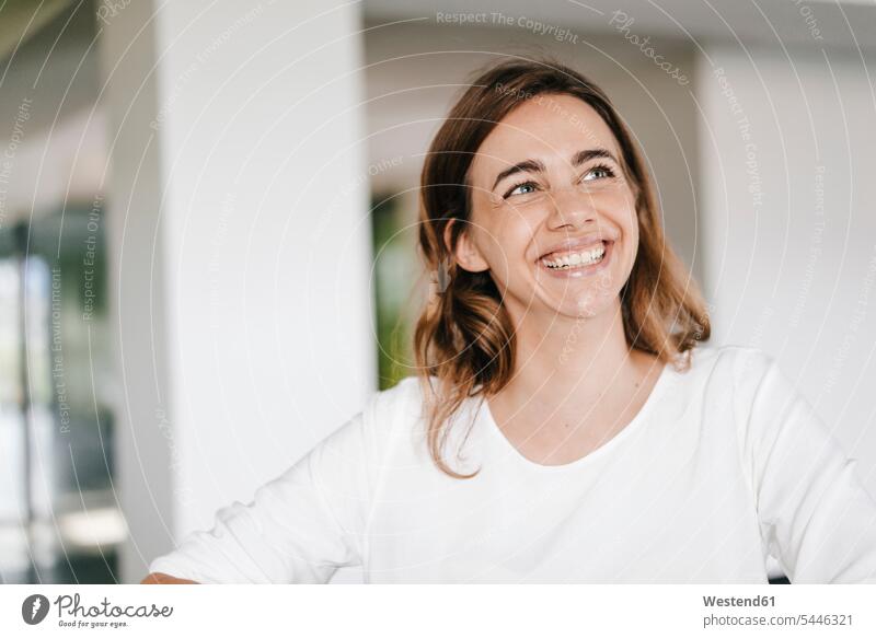 Portrait of a beaming young businesswoman businesswomen business woman business women smiling smile portrait portraits happiness happy Success successful office