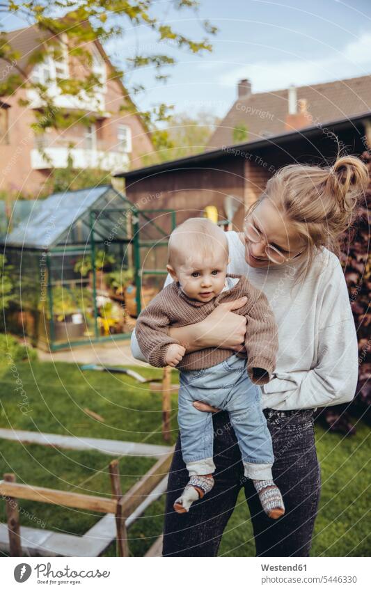 Mother with baby boy in the garden baby boys male infants nurselings babies gardens domestic garden people persons human being humans human beings manchild