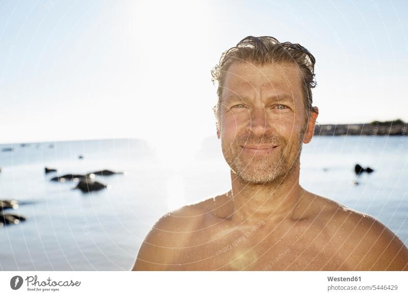 Portrait of smiling man in front of the sea portrait portraits men males Adults grown-ups grownups adult people persons human being humans human beings Sea