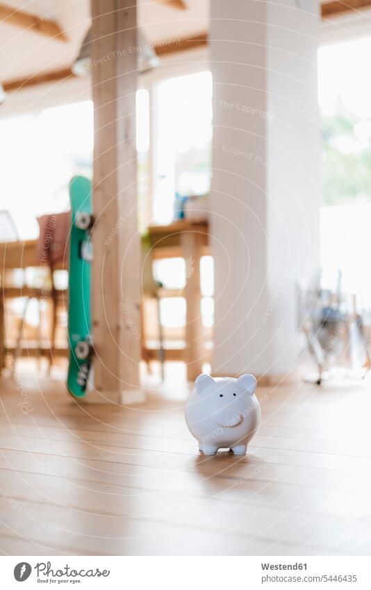 Piggy bank on wooden floor in a loft lofts convenience amenities convenient amenity comfort Money investment finances financial saving save savings