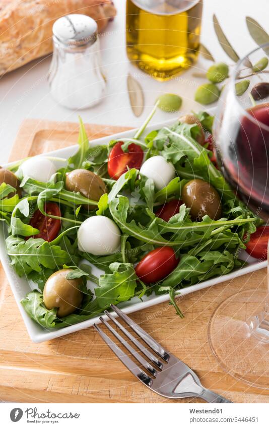 Rocket salad with olive, tomato and mozzarella, olive oil, red wine Rocket Salad Arugulas Roquette healthy eating nutrition Fork Forks Plate dish dishes Plates