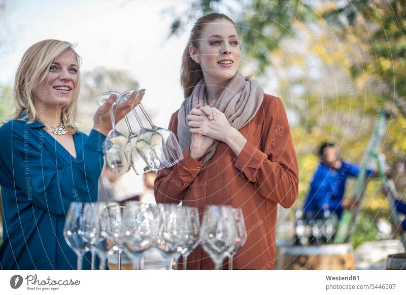 Two women with wine glasses outdoors wine estate wine farm Wine Glass Wine Glasses Wineglass Wineglasses Wine Tasting wine-tasting winetasting salesperson