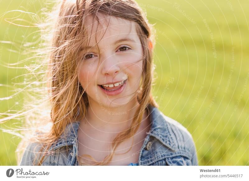 Portrait of smiling girl with blowing hair females girls portrait portraits Windswept Windblown Windy child children kid kids people persons human being humans
