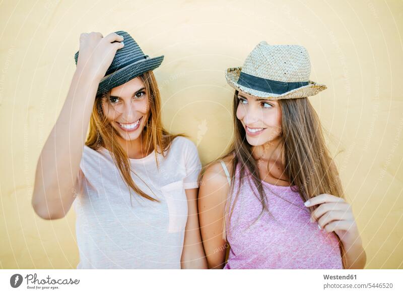 Portrait of two smiling women wearing hats portrait portraits smile female friends woman females happiness happy mate friendship Adults grown-ups grownups adult