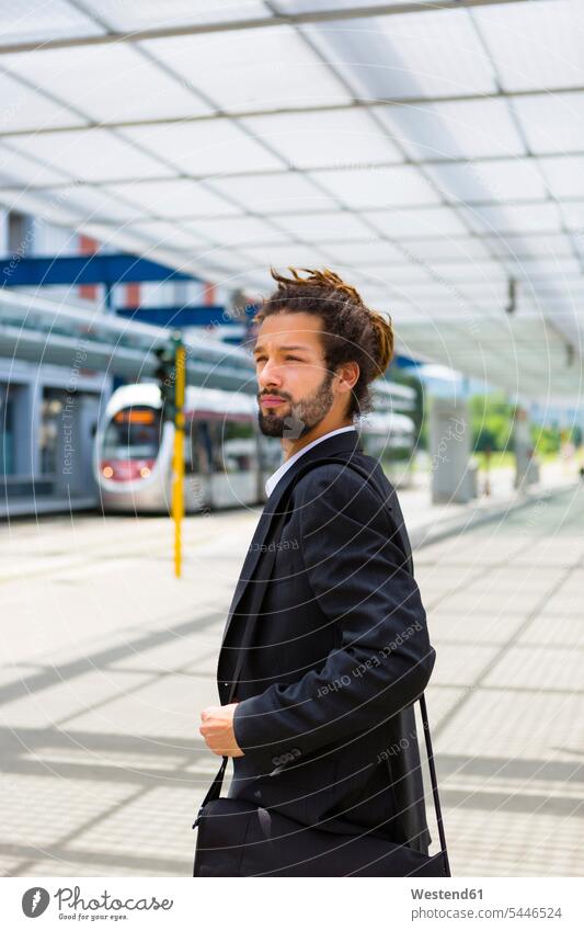 Portrait of young businessman with dreadlocks waiting at station Businessman Business man Businessmen Business men portrait portraits business people