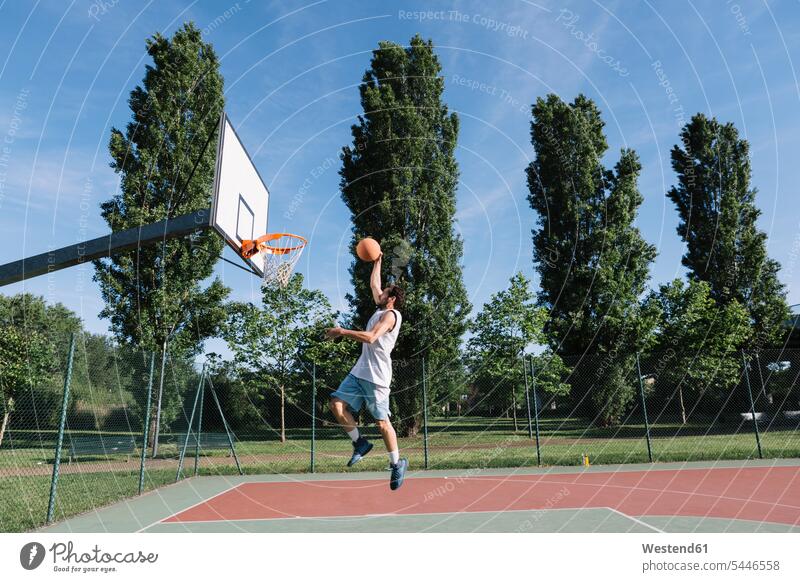 Man playing basketball basketballs jumping Leaping leisure free time leisure time sport sports man men males basketball player basketball players throwing