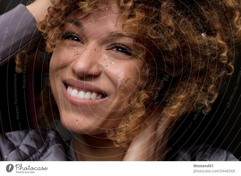 Portrait of happy woman with confetti on her face portrait portraits happiness faces females women head heads people persons human being humans human beings