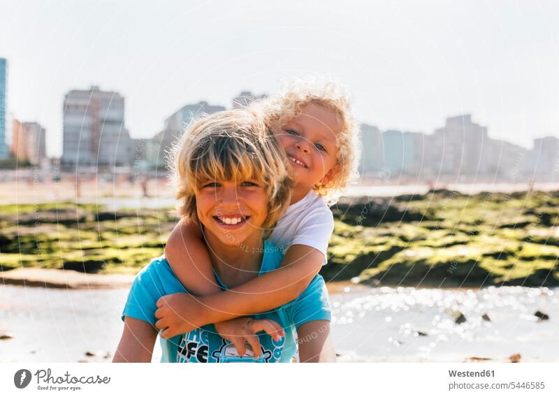 Portrait of two happy brothers on the beach portrait portraits boy boys males child children kid kids people persons human being humans human beings siblings
