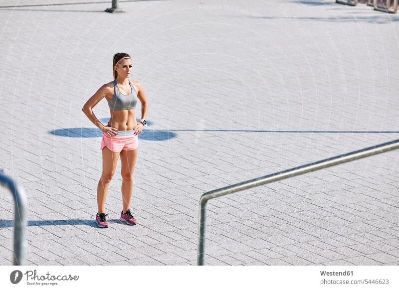 Portrait of young woman getting ready for outdoors workout standing working out work out females women portrait portraits Adults grown-ups grownups adult people