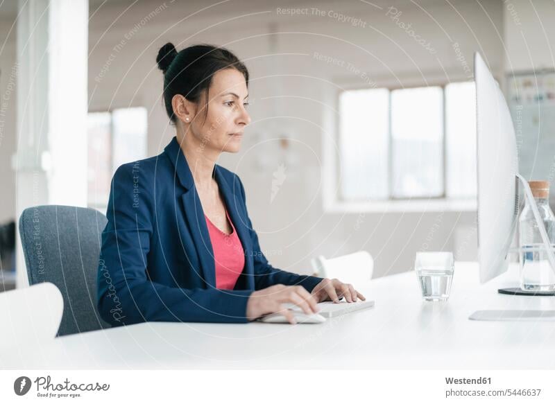 Woman working at desk in a loft computer computers desks woman females women Table Tables Adults grown-ups grownups adult people persons human being humans