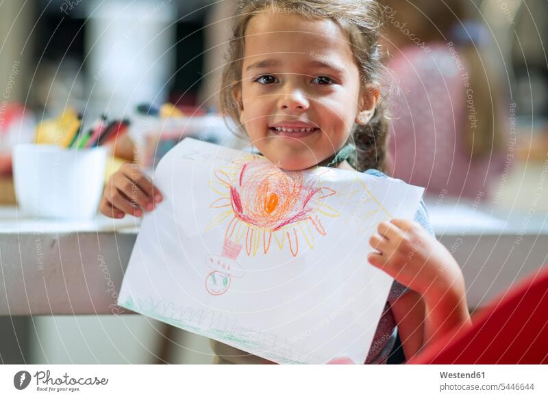 Smiling girl showing drawing Showing portrait portraits drawings smiling smile image images picture pictures child's drawing children's drawing Child's Drawings