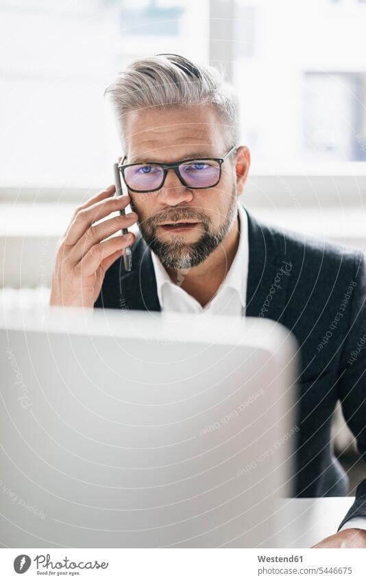 Businessman working in office using computer Office Offices Business man Businessmen Business men business people businesspeople business world business life