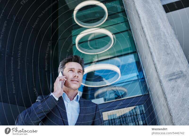 Portrait of businessman on the phone Businessman Business man Businessmen Business men portrait portraits call telephoning On The Telephone calling