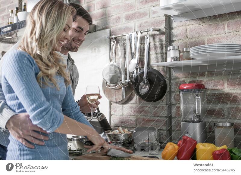 Couple cooking in kitchen domestic kitchen kitchens couple twosomes partnership couples smiling smile people persons human being humans human beings