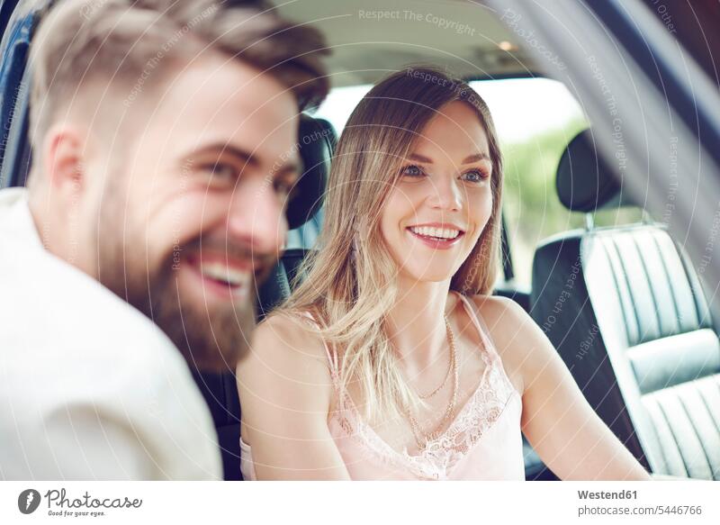 Happy young couple in car automobile Auto cars motorcars Automobiles smiling smile twosomes partnership couples happiness happy motor vehicle road vehicle